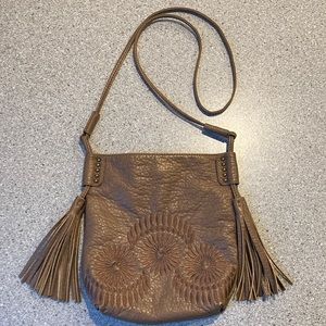 Taupe leather like soft bag. 44” length strap, with 3 tassels. Magnetic close
